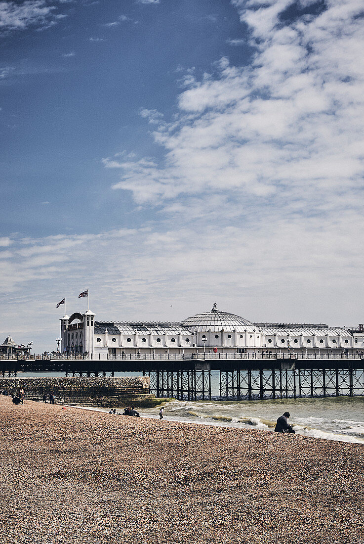 Brighton Beach and a view of the Brighton Pier on a spring day, Brighton, East Sussex, UK.