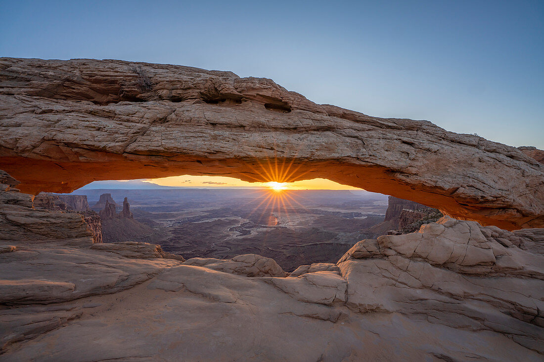 Sunrise at Mesa Arch with glowing arch and sunburst, Canyonlands National Park, Utah, United States of America, North America