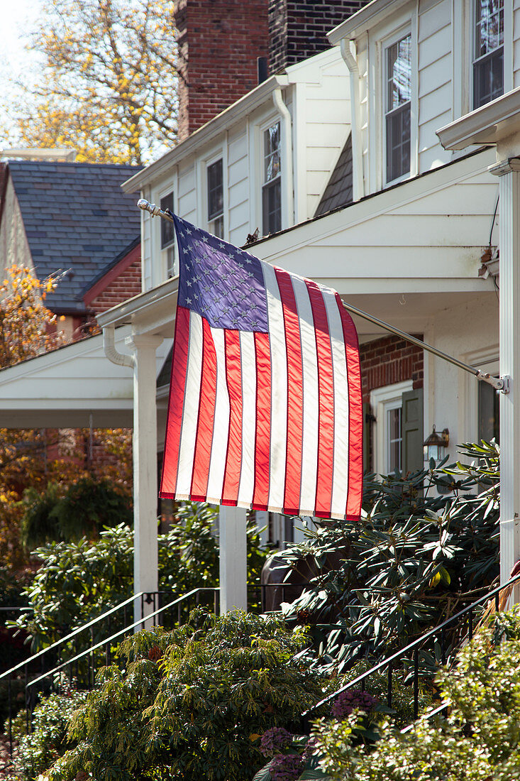 American flag hanging in front of Suburban House
