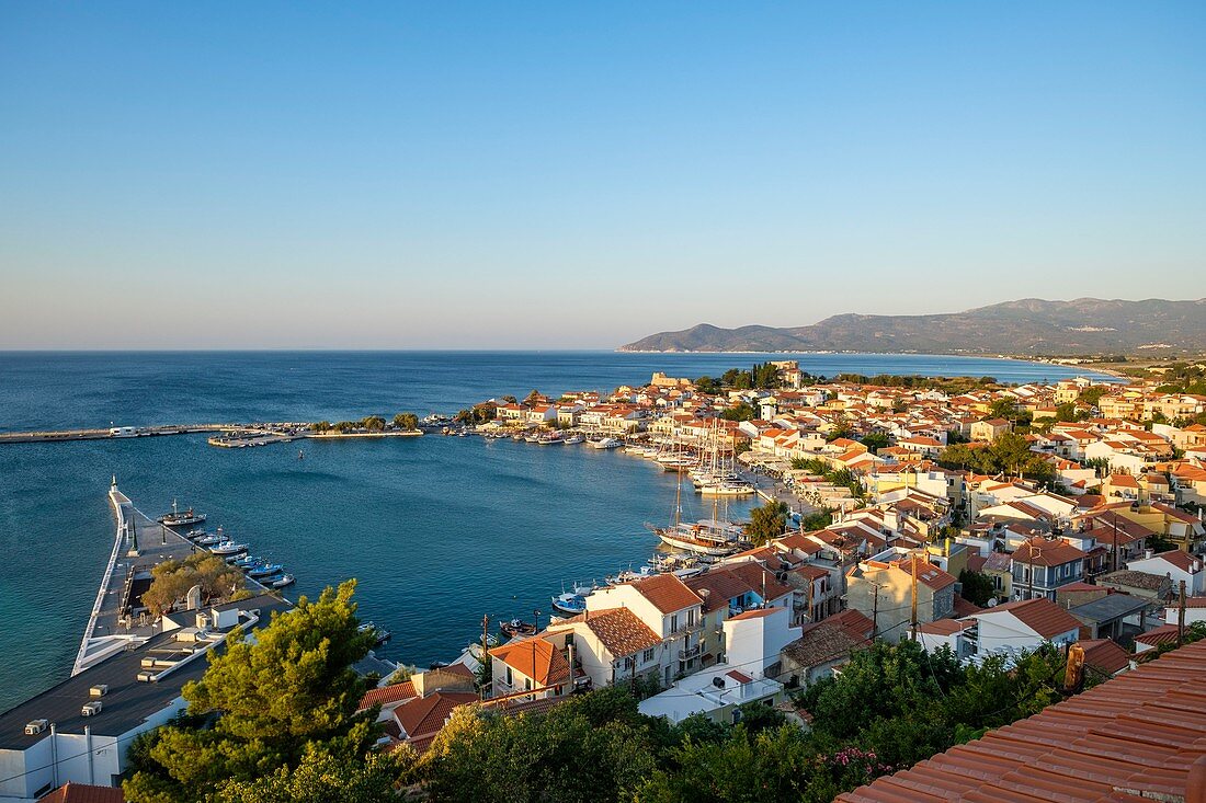 Greece, Samos island, Pythagoreion built on the remains of a former fortified town, a UNESCO World Heritage site, the harbour at sunrise dominated by Lykourgos Logothetis castle and Transfiguration (or Metamorphosis) church 