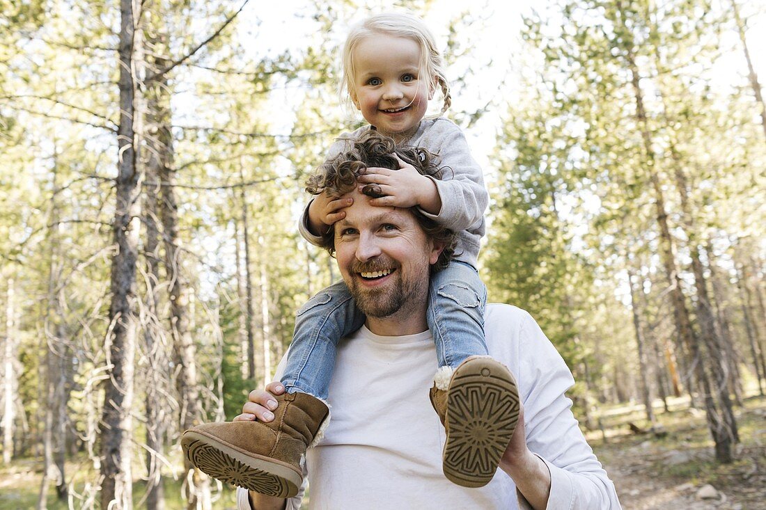 Father carrying little daughter (2-3) on shoulders in Uinta-Wasatch-Cache National Forest