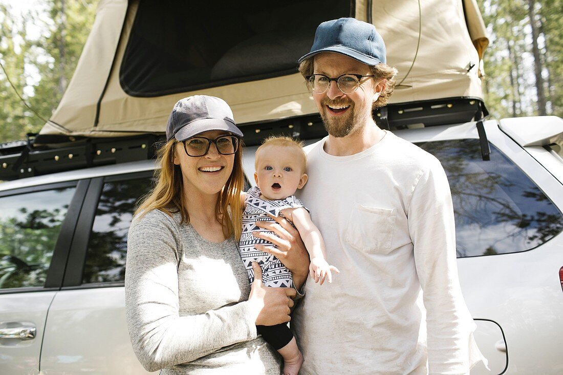 Portrait of parents with baby son (6-11 months) on camping in forest,Wasatch Cache National Forest