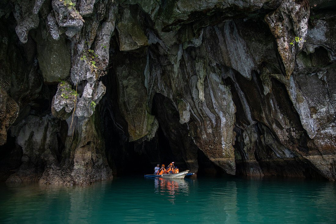 Visitors in canoes exiting caves of the underground river in the Puerto Princesa Subterranean River National Park, Cabayugan, Puerto Princesa, Puerto Princesa, Philippines, Asia