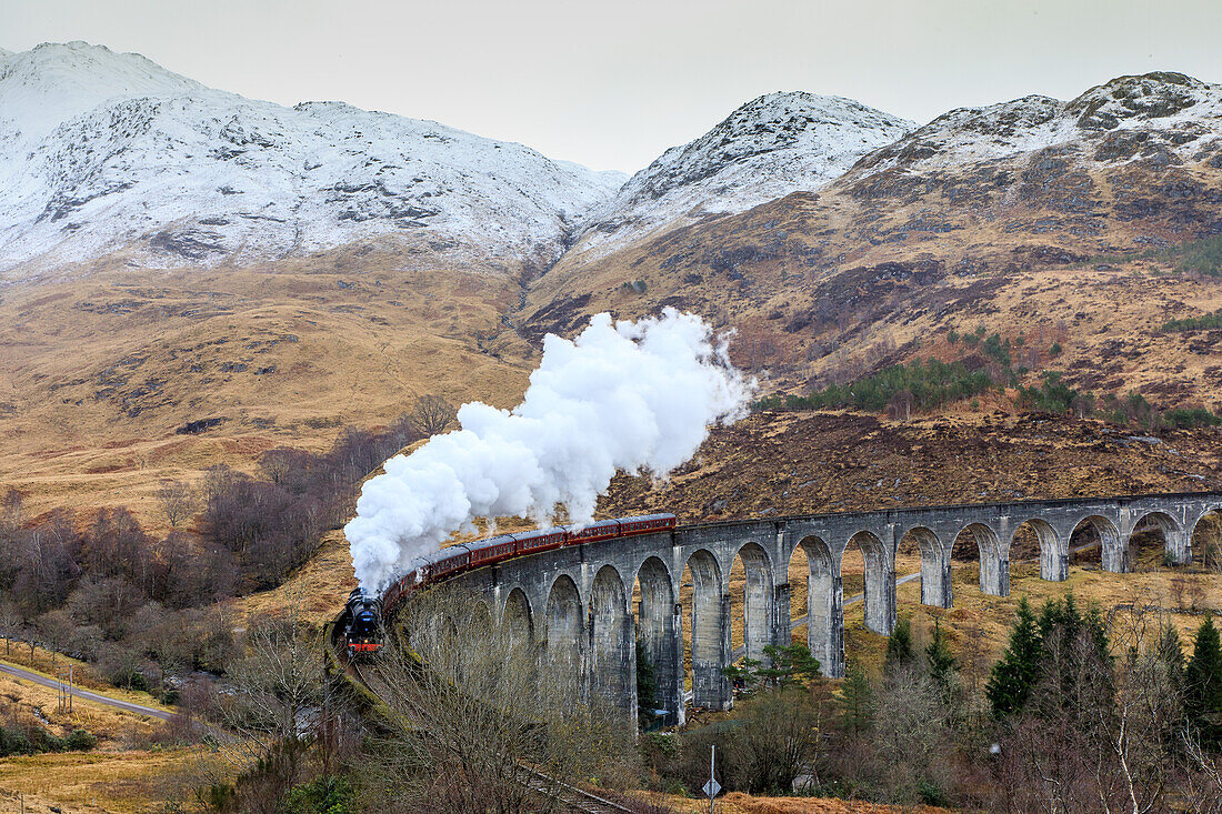 Steam train &quot;Jacobite Express&quot; under smoke, Glenfinnan Viaduct, Highlands, Scotland, UK
