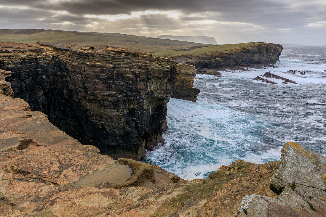 Storm, surf breaker, sandstone cliffs of Yesnaby, clusters of rays, Orkney, Scotland UK
