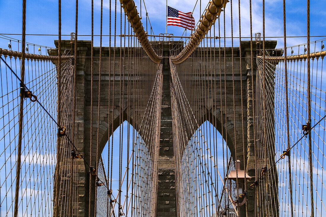 The ropes of the bridge tower of the Brooklyn Bridge in New York are attached symmetrically