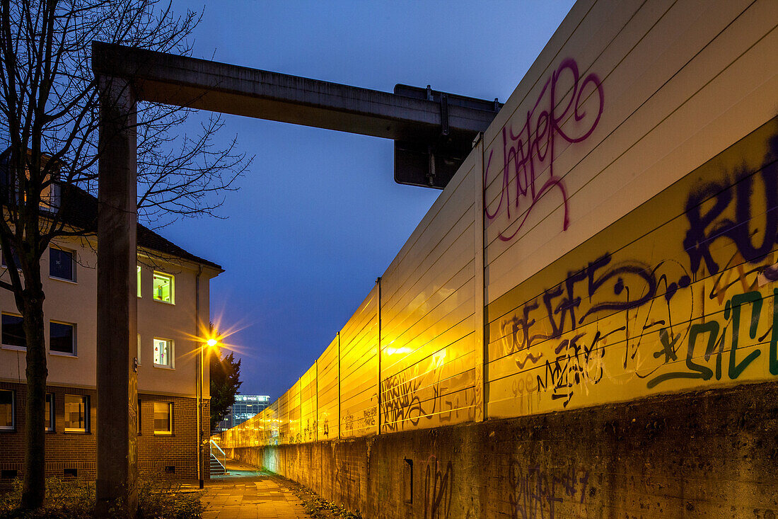 high noise protection wall on the A40 in Essen, noise protection, graffitti, residential area next to German Autobahn,