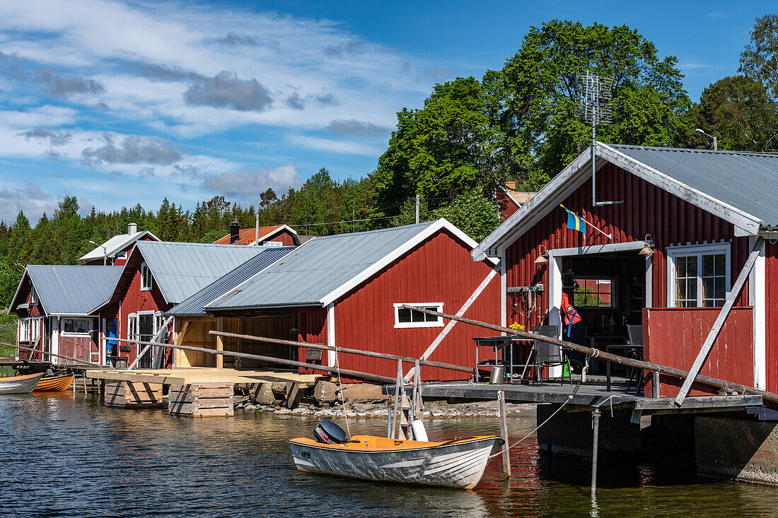 Typical red boathouses by the sea near Härnösand, Västernorrland, Sweden