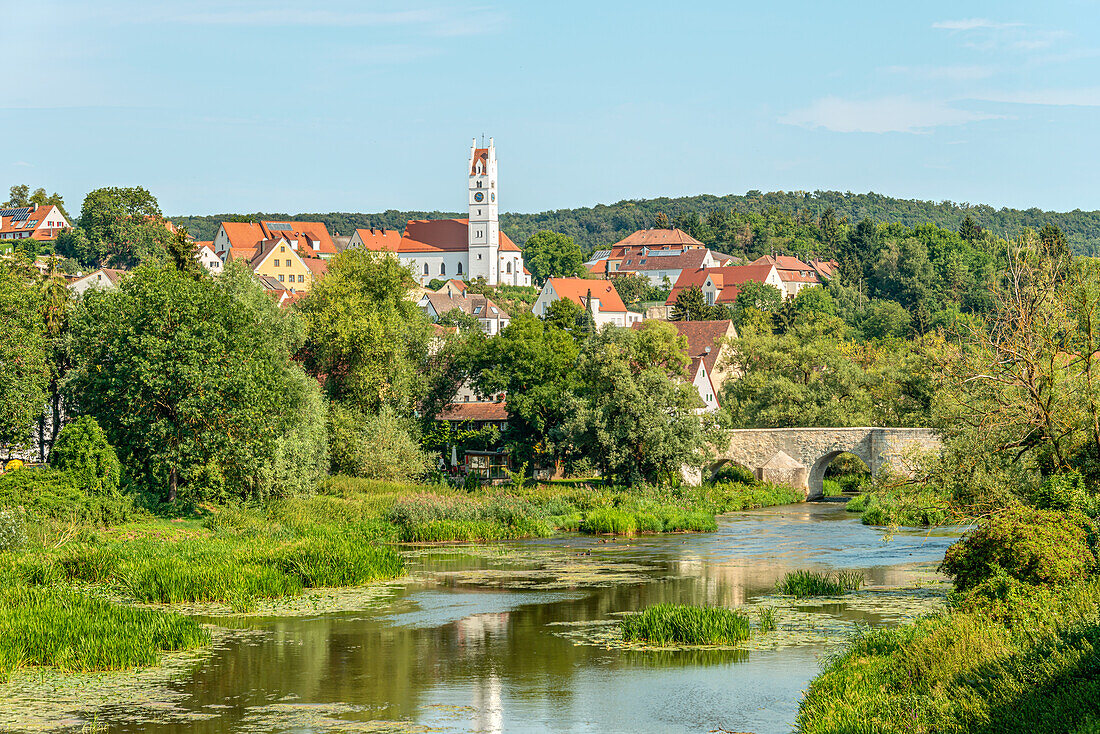 River landscape in the valley of the Wörnitz near Harburg with the Herz-Jesu Church in the background, Swabia, Bavaria, Germany