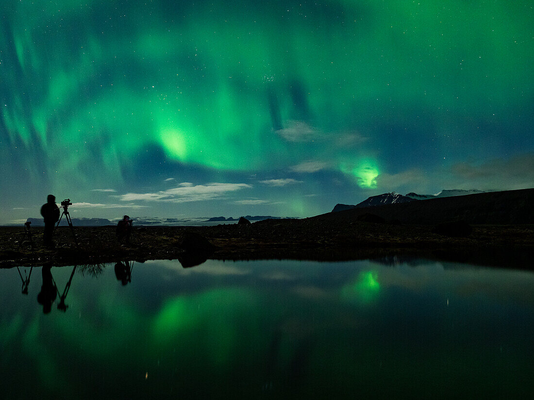 Photographers take pictures of northern lights, aurora borealis, south Iceland, Europe