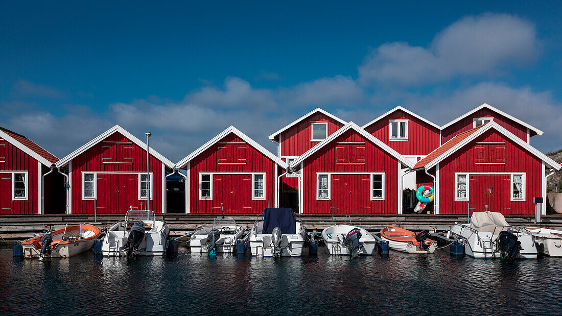Red boathouses with boats on the archipelago island of Tjörn in the west of Sweden