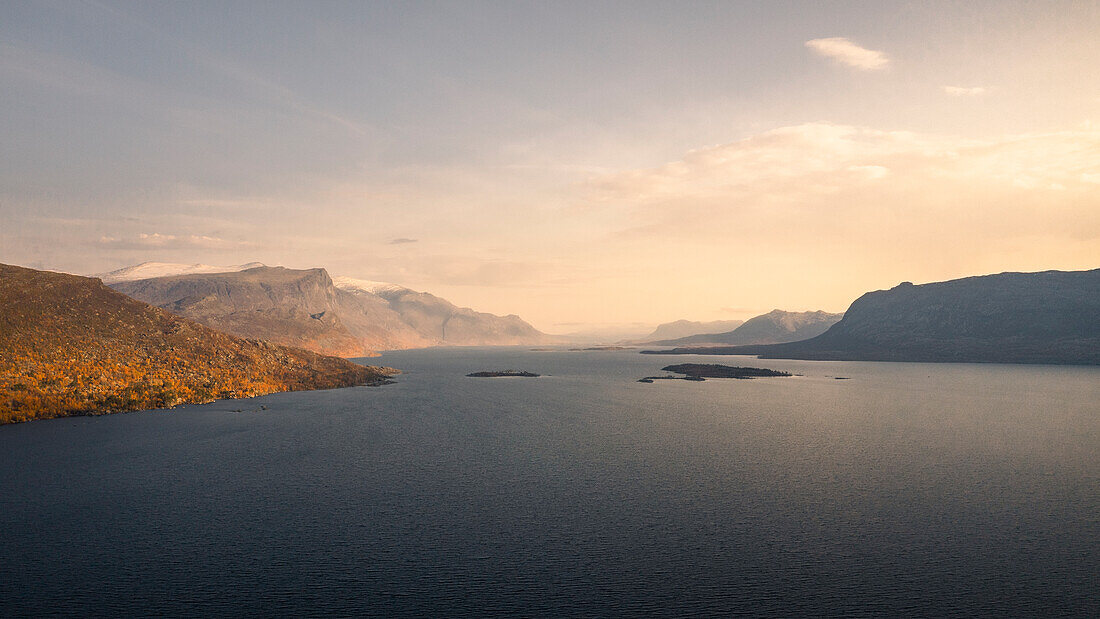 Landschaft mit Bergen und See im Stora Sjöfallet Nationalpark im Herbst in Lappland in Schweden von oben\n