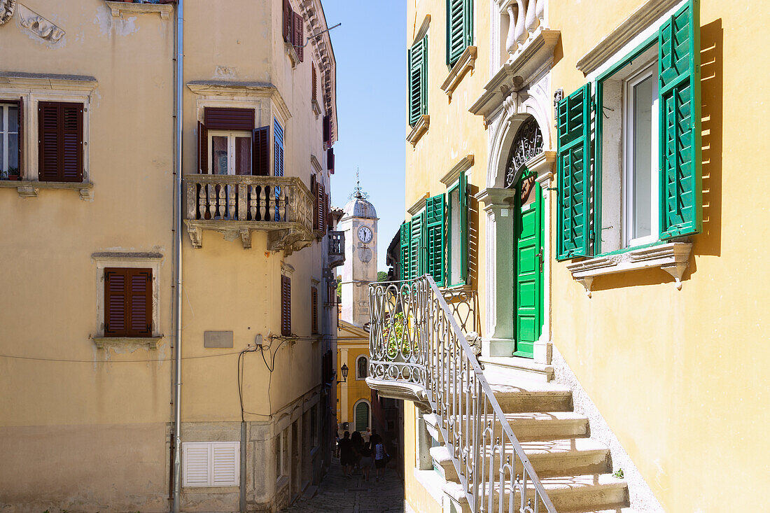 Labin, alley and houses with a view of Venetian clock tower