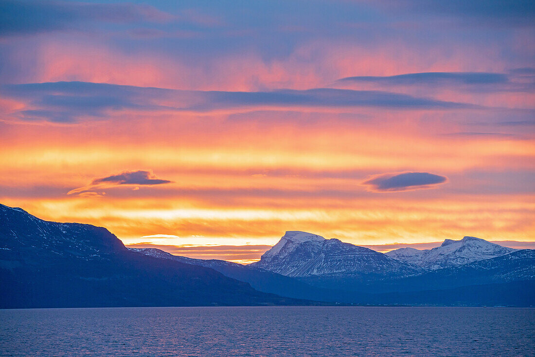 Morning red color of a mountain range north of Harstad, Hurtigrute, Nordland, Norway, Europe