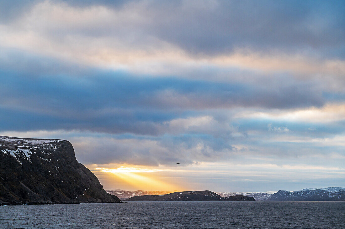 View of the sunlit mountain ranges in front of Honningsvag, Finnmark, Norway, Europe