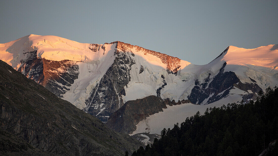 Snow-covered mountain peaks of the Morteratsch Glacier in the Engadin in the Swiss Alps in sunset