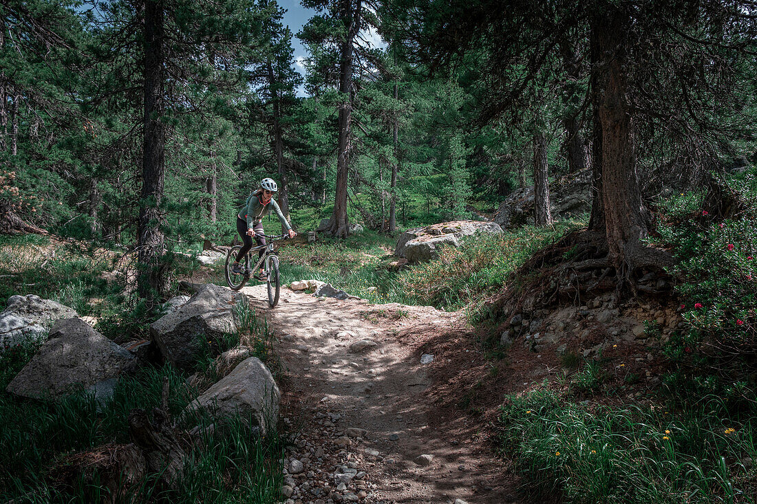 Mountain biking on the Bernina Express trail route from the Lago Bianco reservoir to Morteratsch