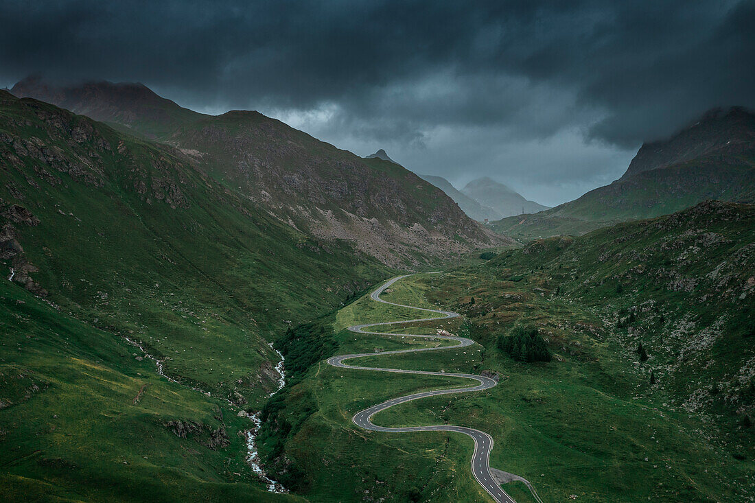 Julier Pass in summer with a dramatic cloudy sky in the Swiss Alps in Graubünden from above