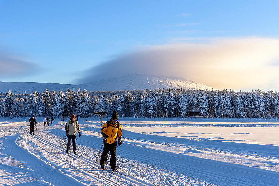 Cross-country skiers on frozen lake at Aekaeslampolo,, Aekaeslampolo, Finland