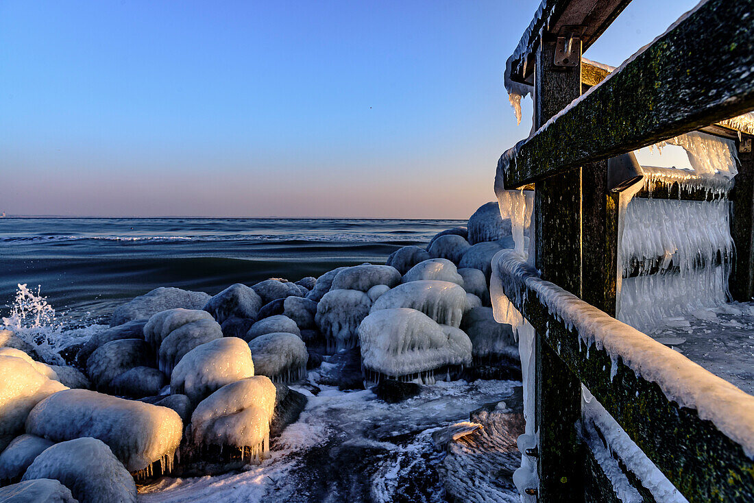 Icy railings and rocks at the port of Niendorf, Bay of Lübeck,  Schleswig Holstein, Germany