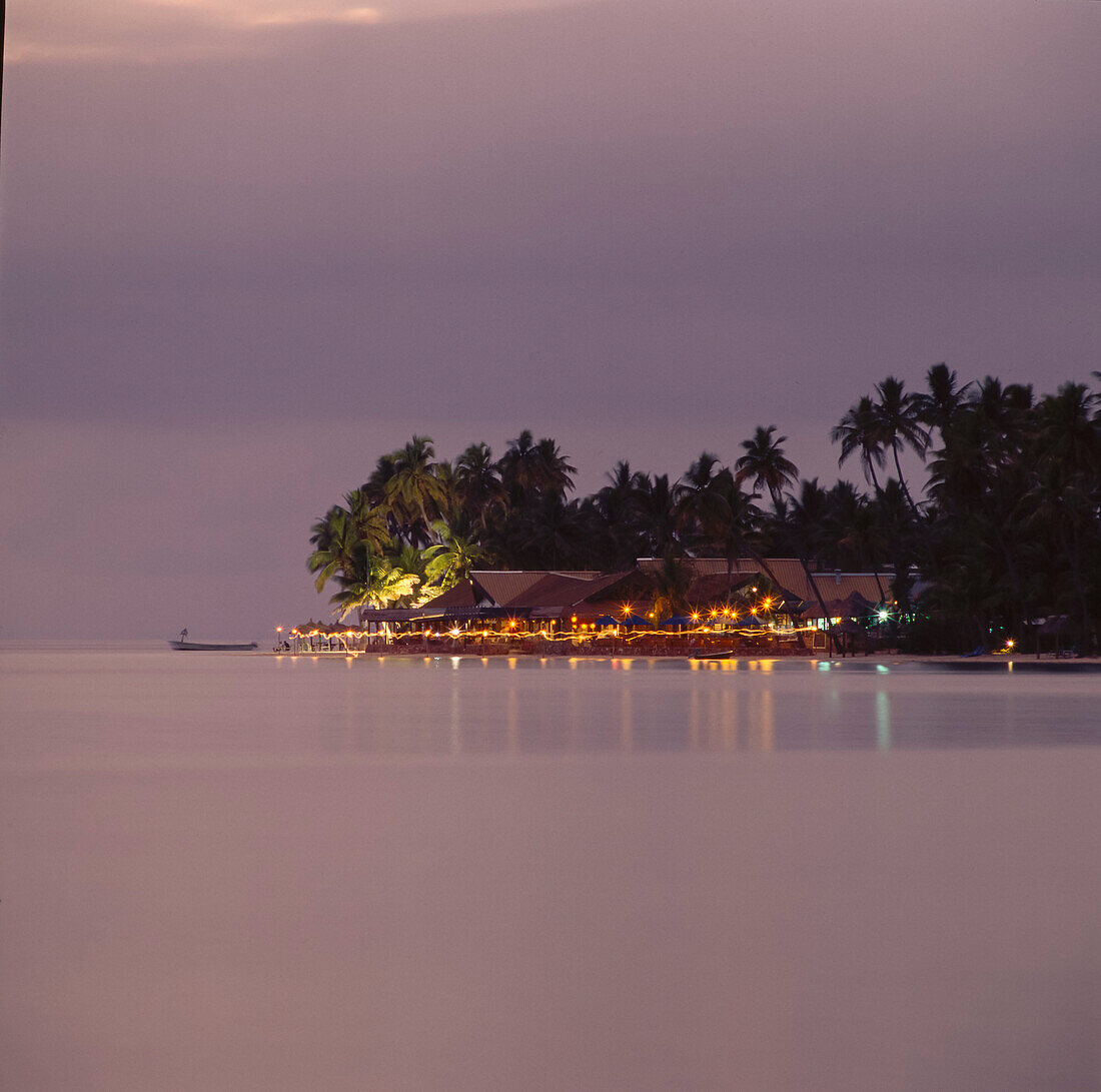 Fijian resort lit up at sunset on Fijian Island