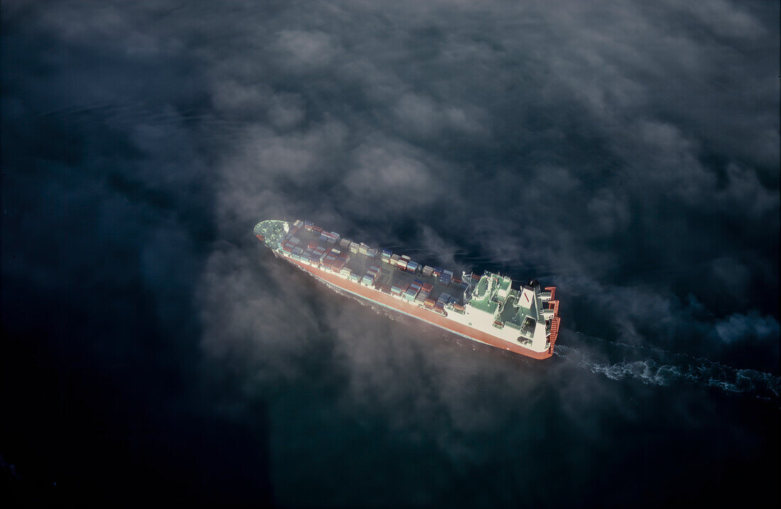 Aerial of Scans Carrier loaded with cargo sailing through fog