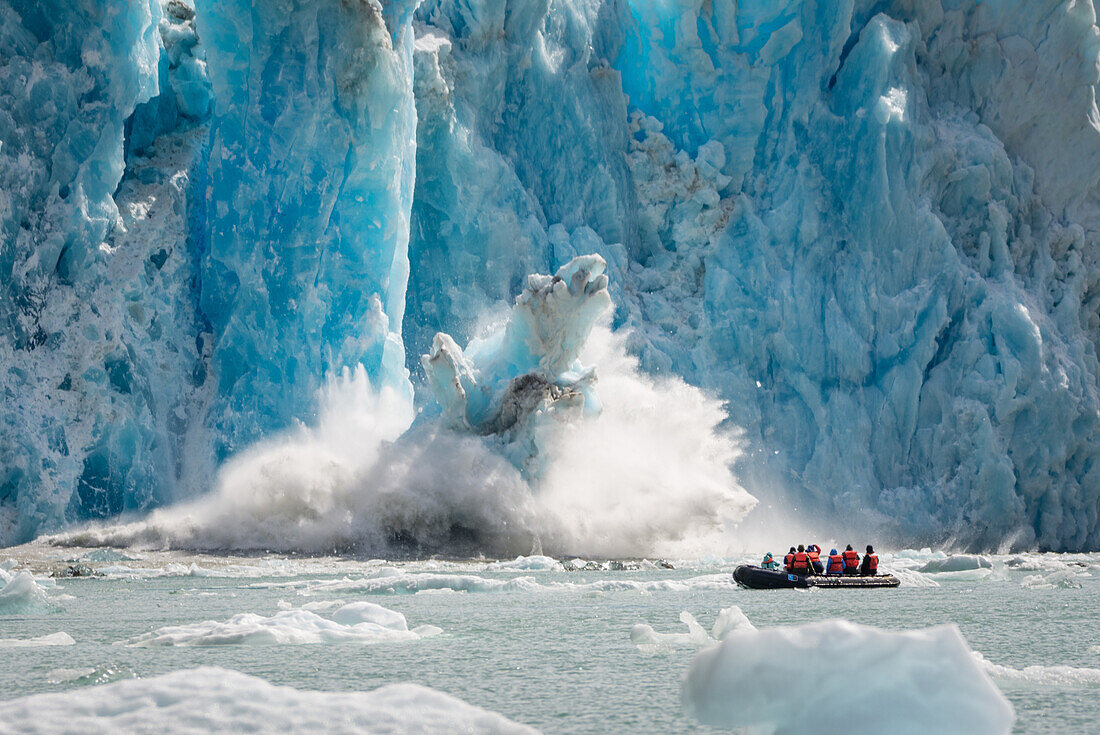 Iceberg calving with zodiac watching