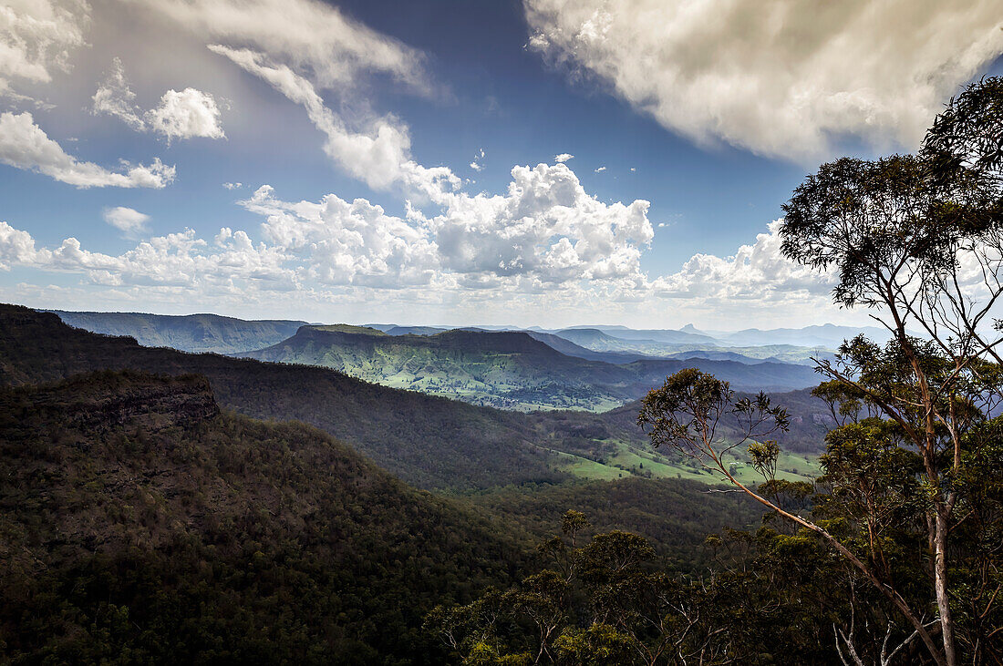 View from Python Rock of sun shing down on Lamington National Park between clouds