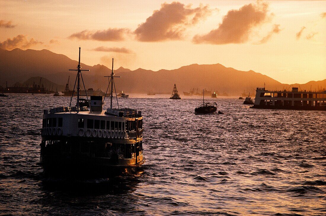 Star Ferry carrying passengers across Victoria Harbour at dusk, Hong Kong