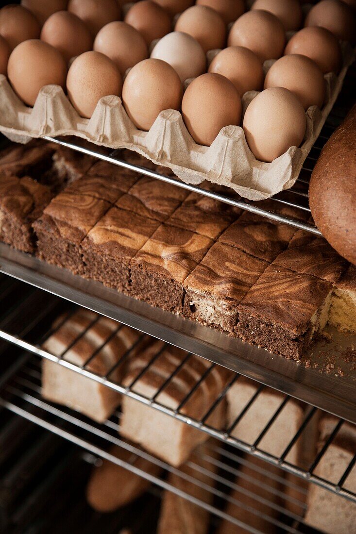 Eggs with marble cake and loaves of breads on wire shelves