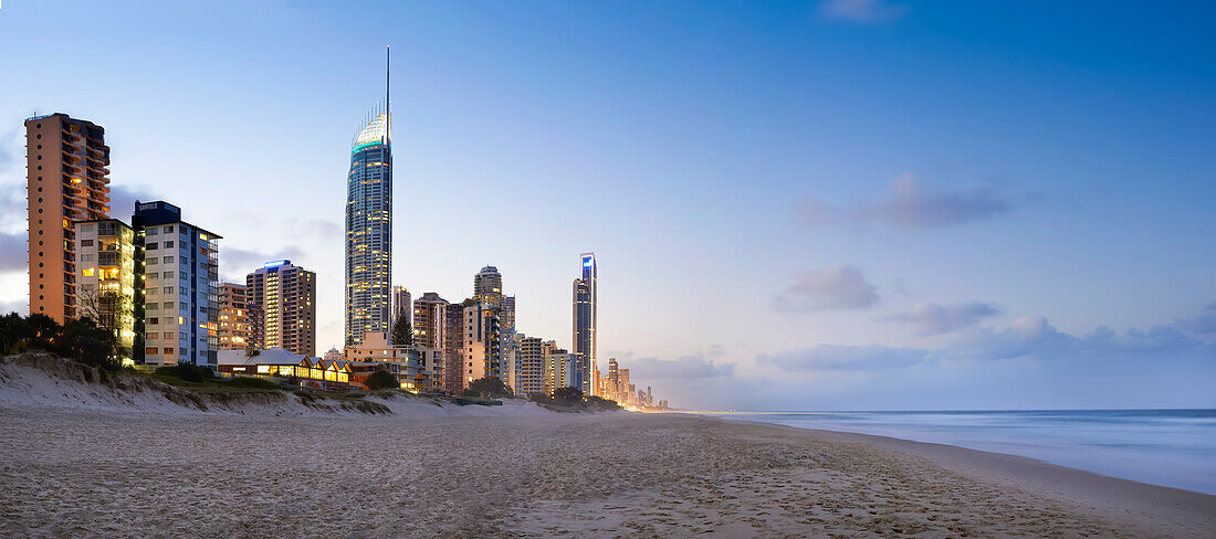 Surfers Paradise lit up in the early evening taken from the beach