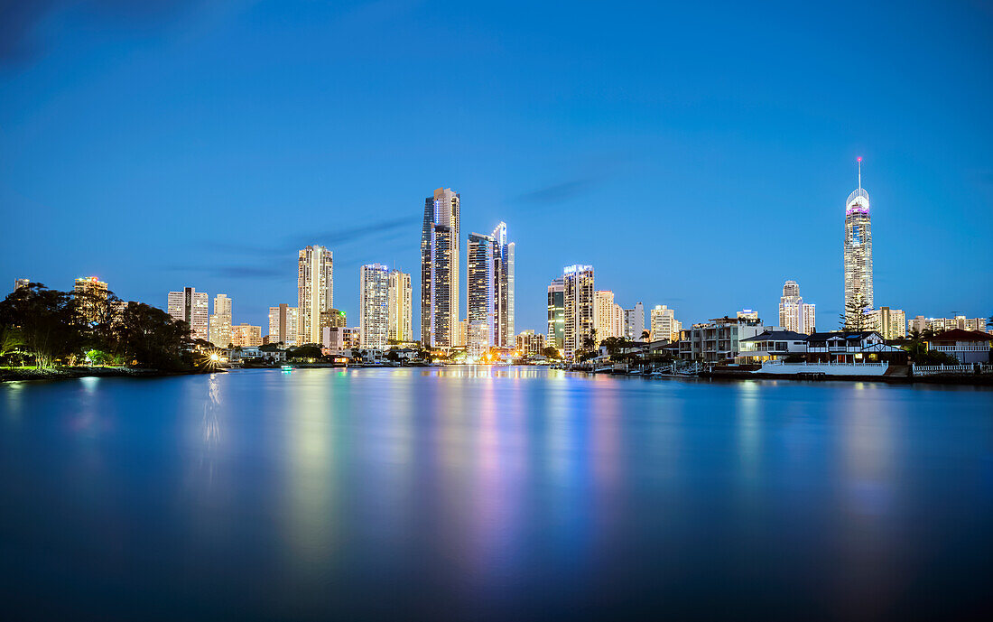 Looking across water to high rise buidings lit up at Surfers Paradise at night