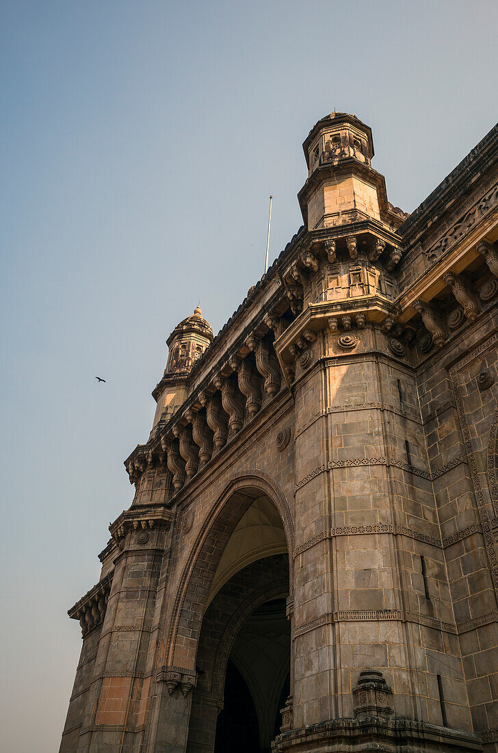 Looking up at stone archway of Gateway of India monument, completed in 1924 and built commemorate the landing of King George V. It is situated on the shore of the Arabian Sea in South Mumbai