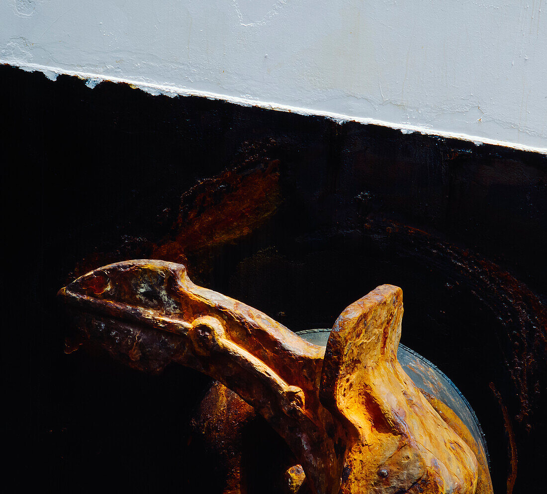 Rusty Anchor against side of ship - close up