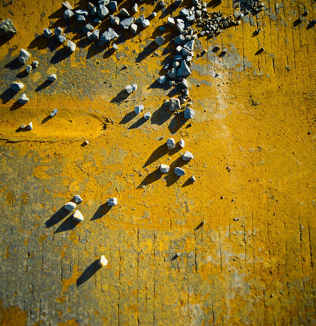 Gravel scattered on rusty steel