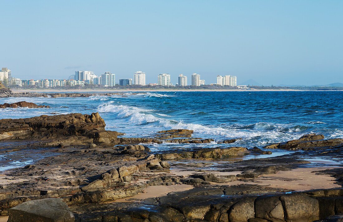 Looking across rocks and waves from Mooloolabah to Maroochydore
