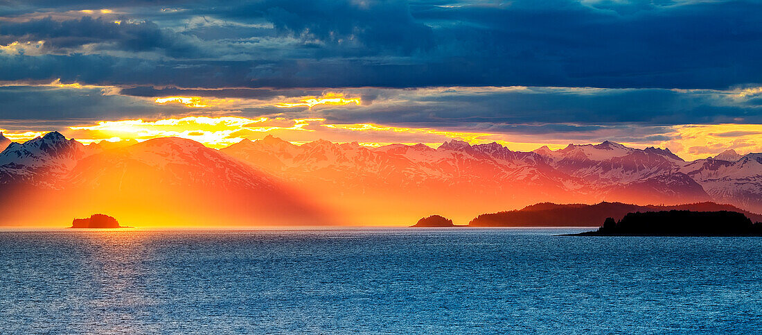 Orange Gold Light and dramatic cloudbursts over the Chilkat Range and Lynn Canal in Alaska