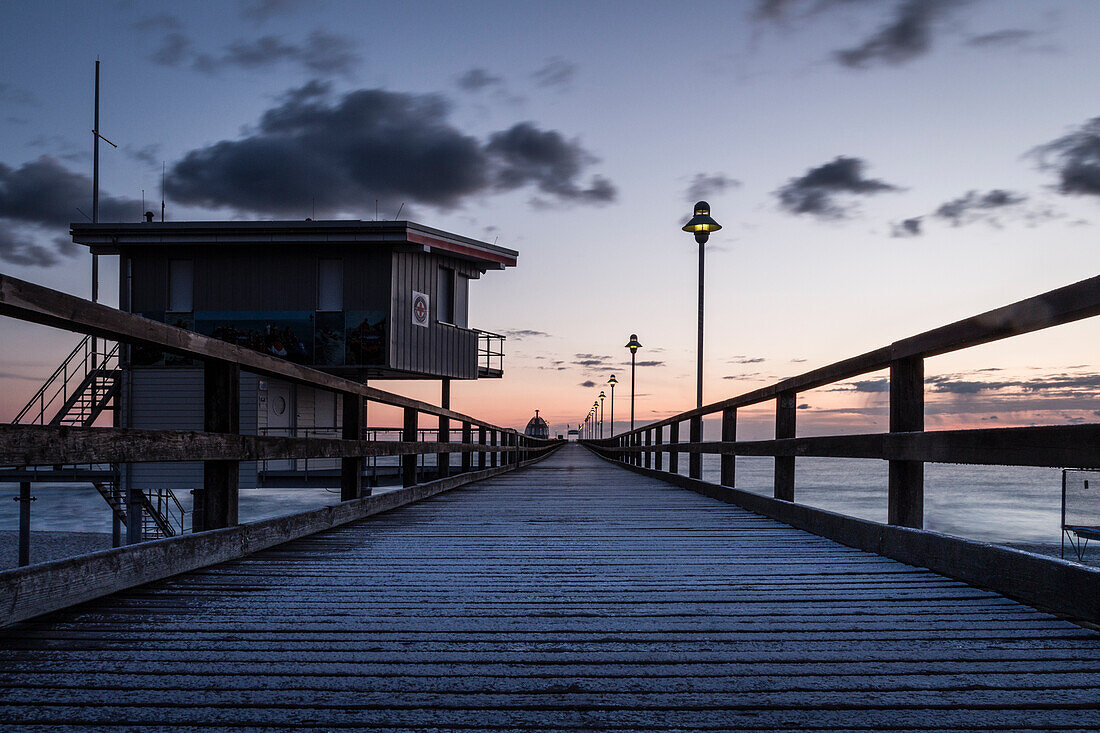 Long exposure at the pier in Zinnowitz on Usedom in the blue hour at sunrise, Germany, Mecklenburg-Western Pomerania, Baltic Sea