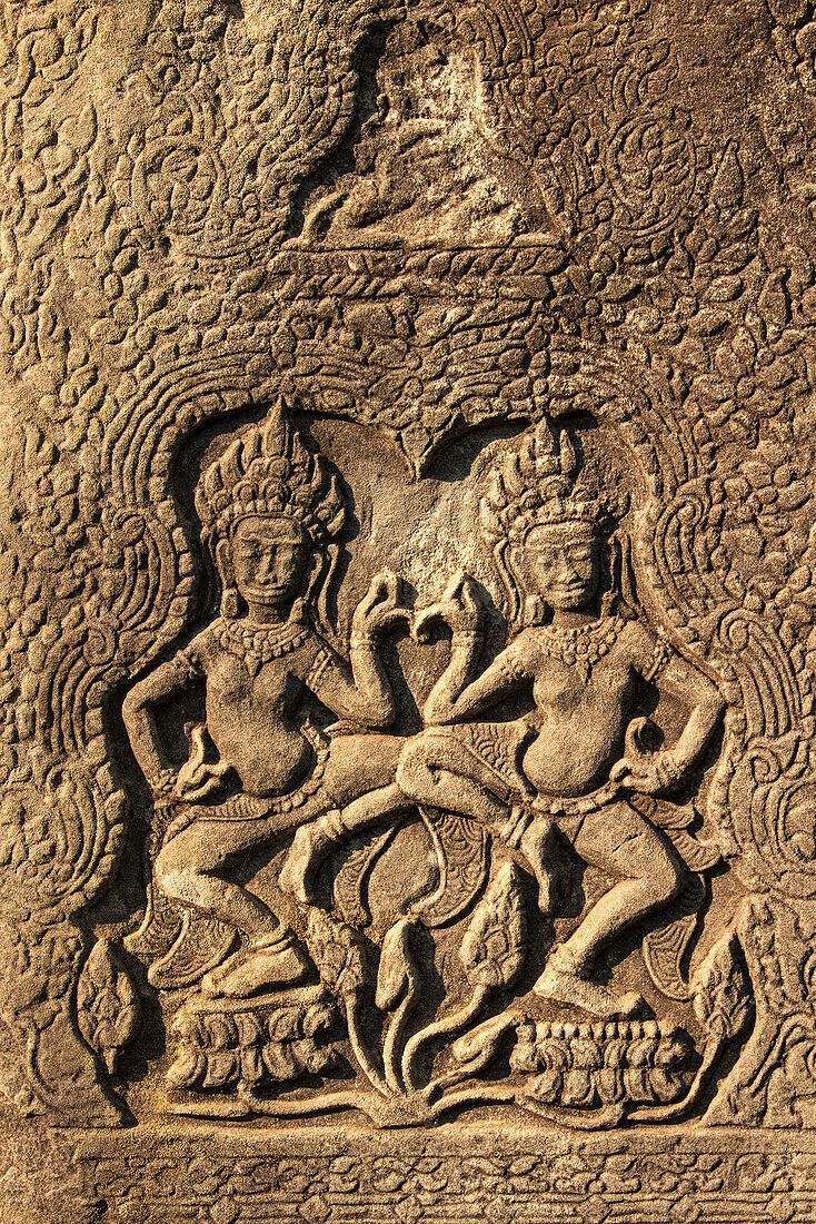 Two Apsara dancers carved into pillars at the Bayon temple of Angkor Thom