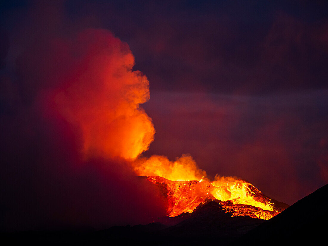 Red bot magma and gas cloud, eruption at night, Fagradalsfjall Volcano from Observation Hill, Iceland
