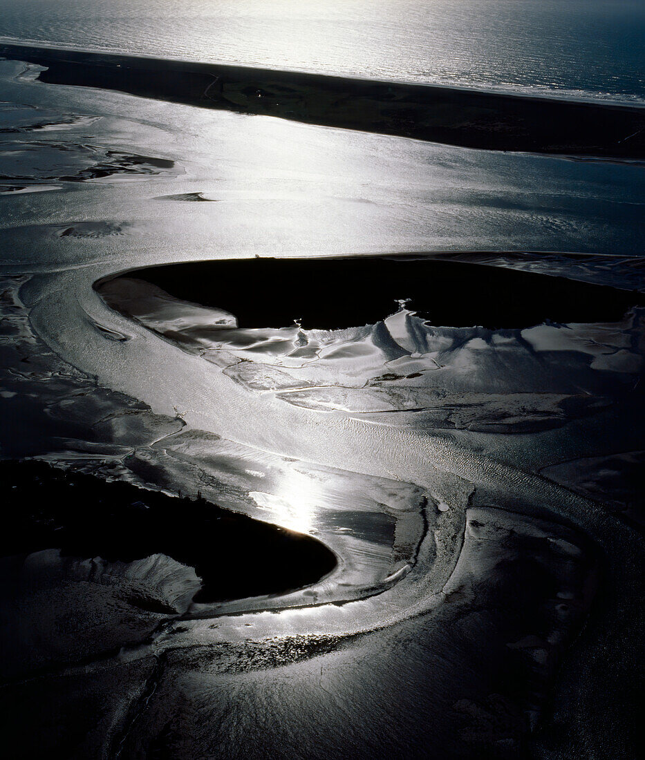 Light shining on Estuary creating patterns in the land