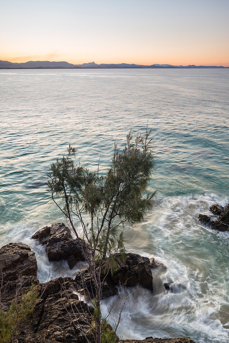 Waves washing over craggy rock on Australian coastline