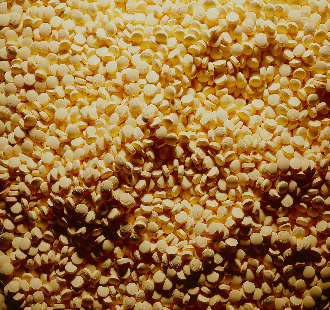 Close up of hundreds of yellow pills