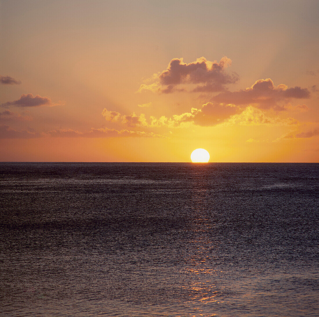 Sun setting over the calm ocean in Guam