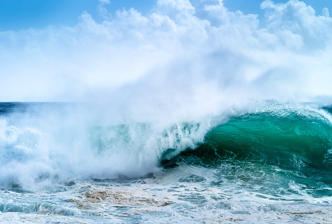 Riesige Welle, die sich während des Zyklons Ola kräuselt und bricht