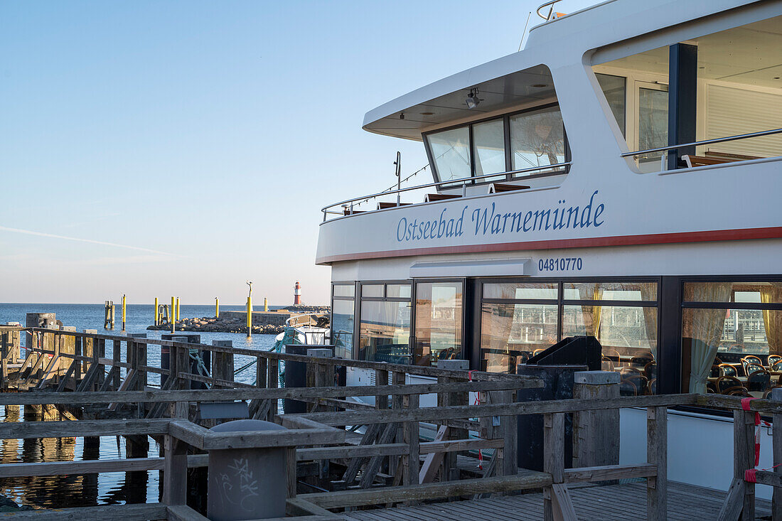 Ships for harbor tours on the old river in Warnemünde near the pier in the morning.