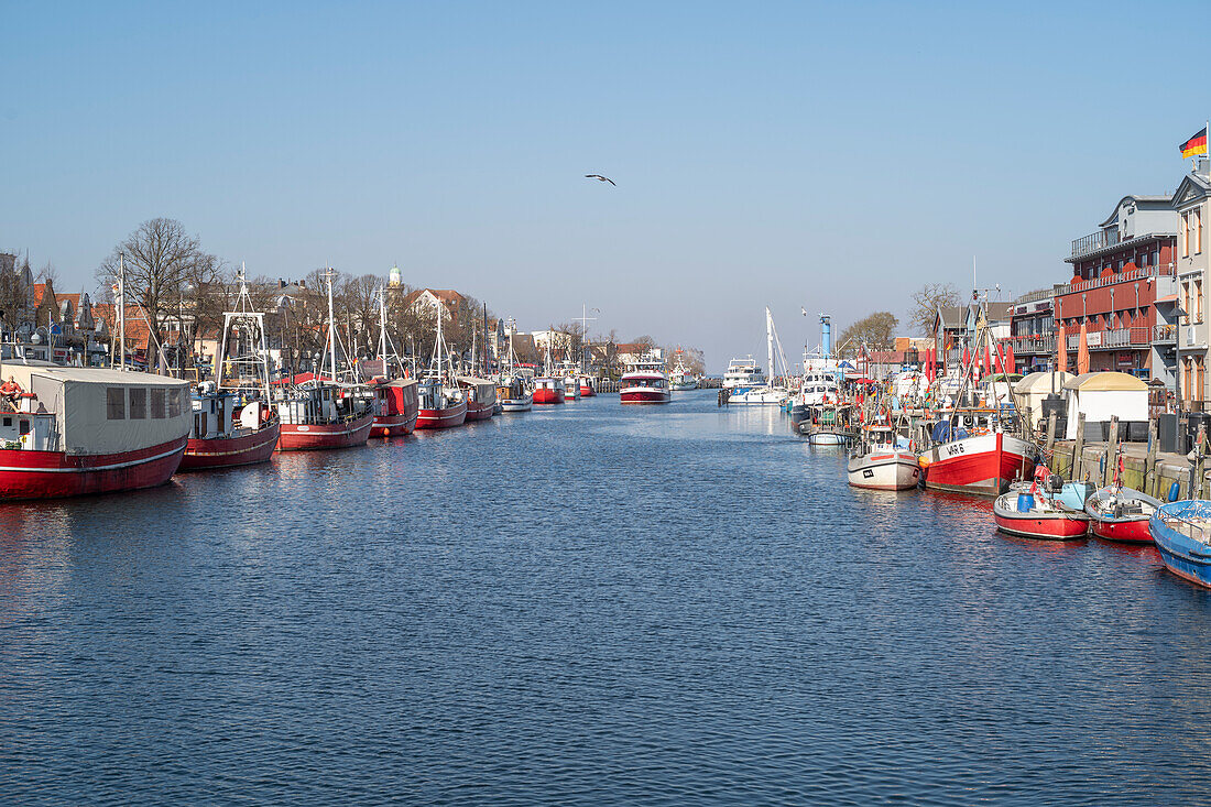 View of the middle pier with a fishing boat in Warnemünde from the station bridge on the old river.