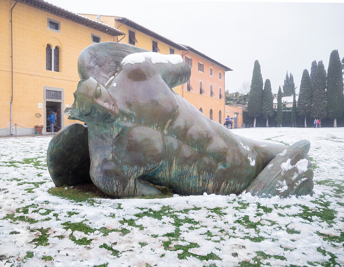 A fallen angel sculpture under a snowy weather, Pisa, Central Italy, Europe
