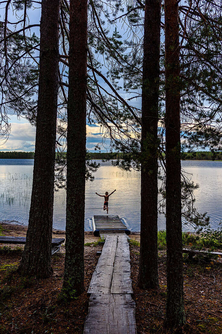 Cooling off in the lake, sauna in the middle of the forest in Patvinsuo National Park, Finland