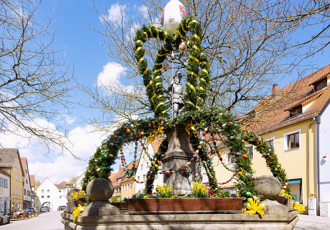 Easter fountain decorated with colorful Easter eggs on the market square in Gräfenberg in Franconian Switzerland, Bavaria, Germany